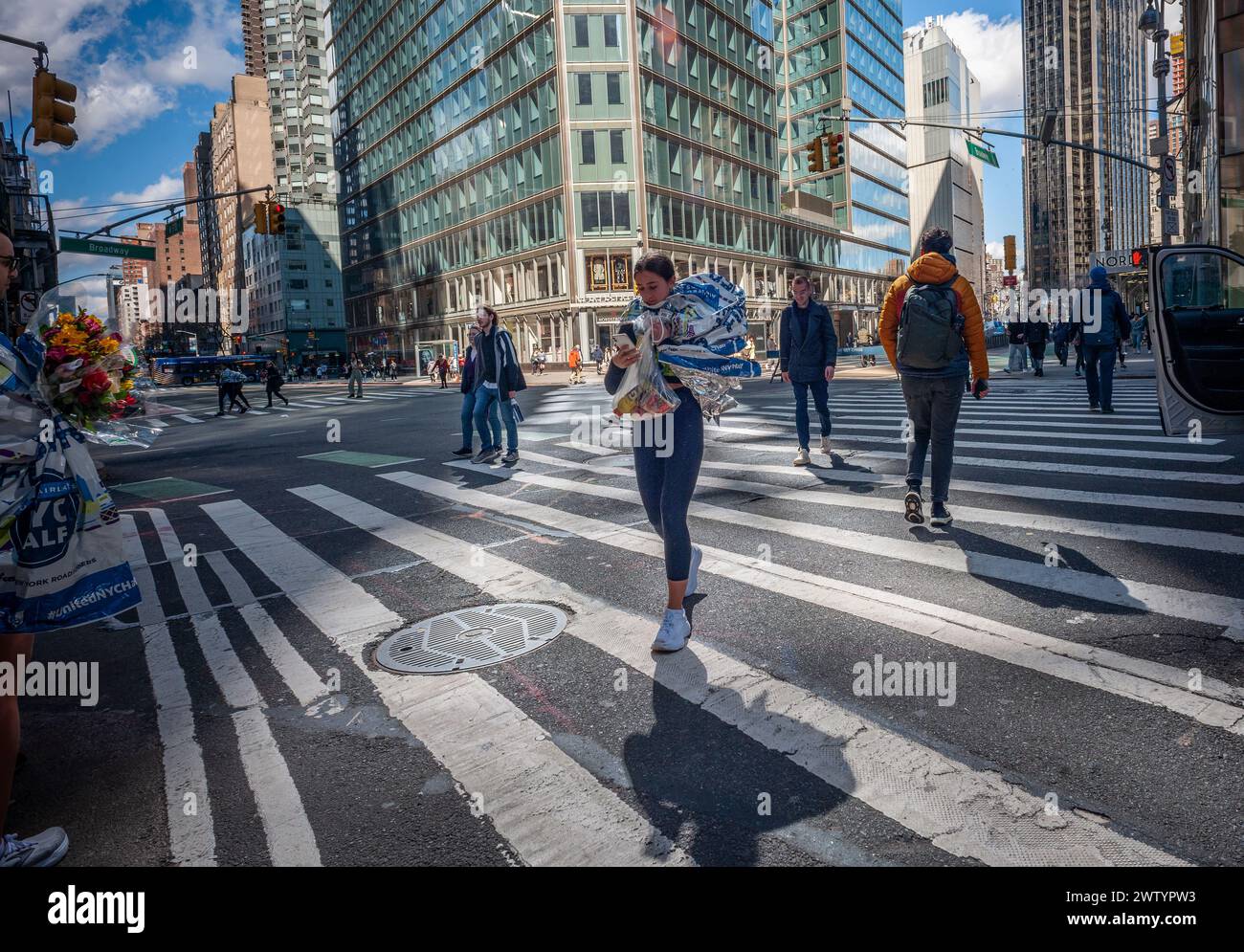 Finishers in the United Airlines Half-Marathon wander about Midtown Manhattan in New York aprs race on Sunday, March 17, 2024.  (© Richard B. Levine) Stock Photo