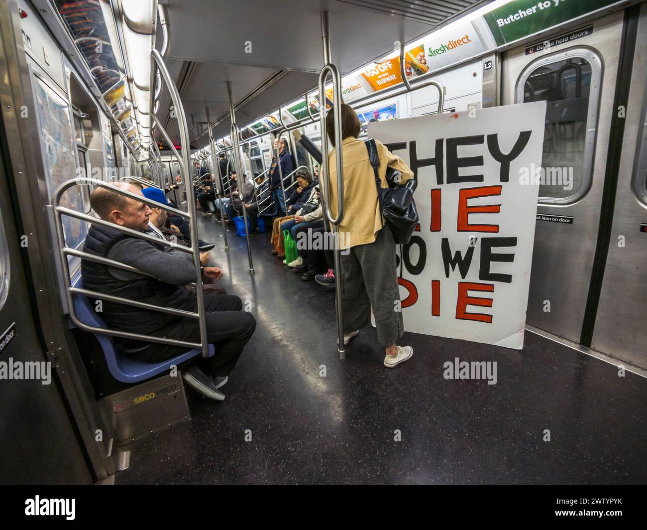 Supporters of the Ukraine return to Brooklyn on the subway from a protest in New York on Saturday, March 16, 2024. (© Richard B. Levine) Stock Photo