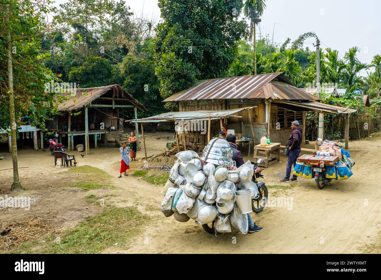 Pots and pans being sold from an overloaded motorcycle on Majuli Island, Assam, India Stock Photo