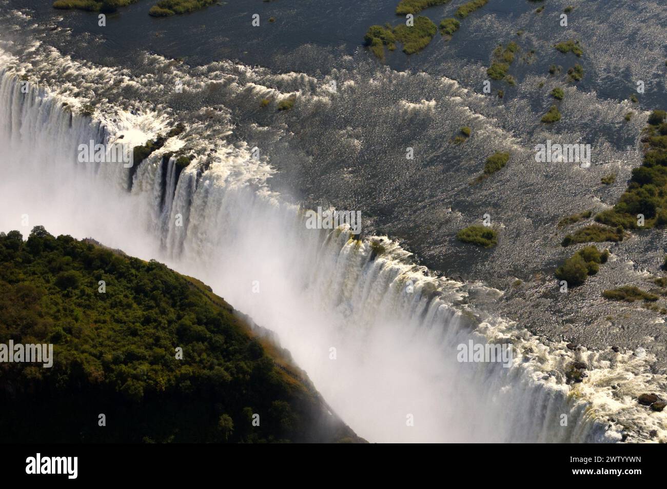 Aerial view of the Zambezi River and thundering Victoria Falls in Zimbabwe, as seen from a helicopter Stock Photo