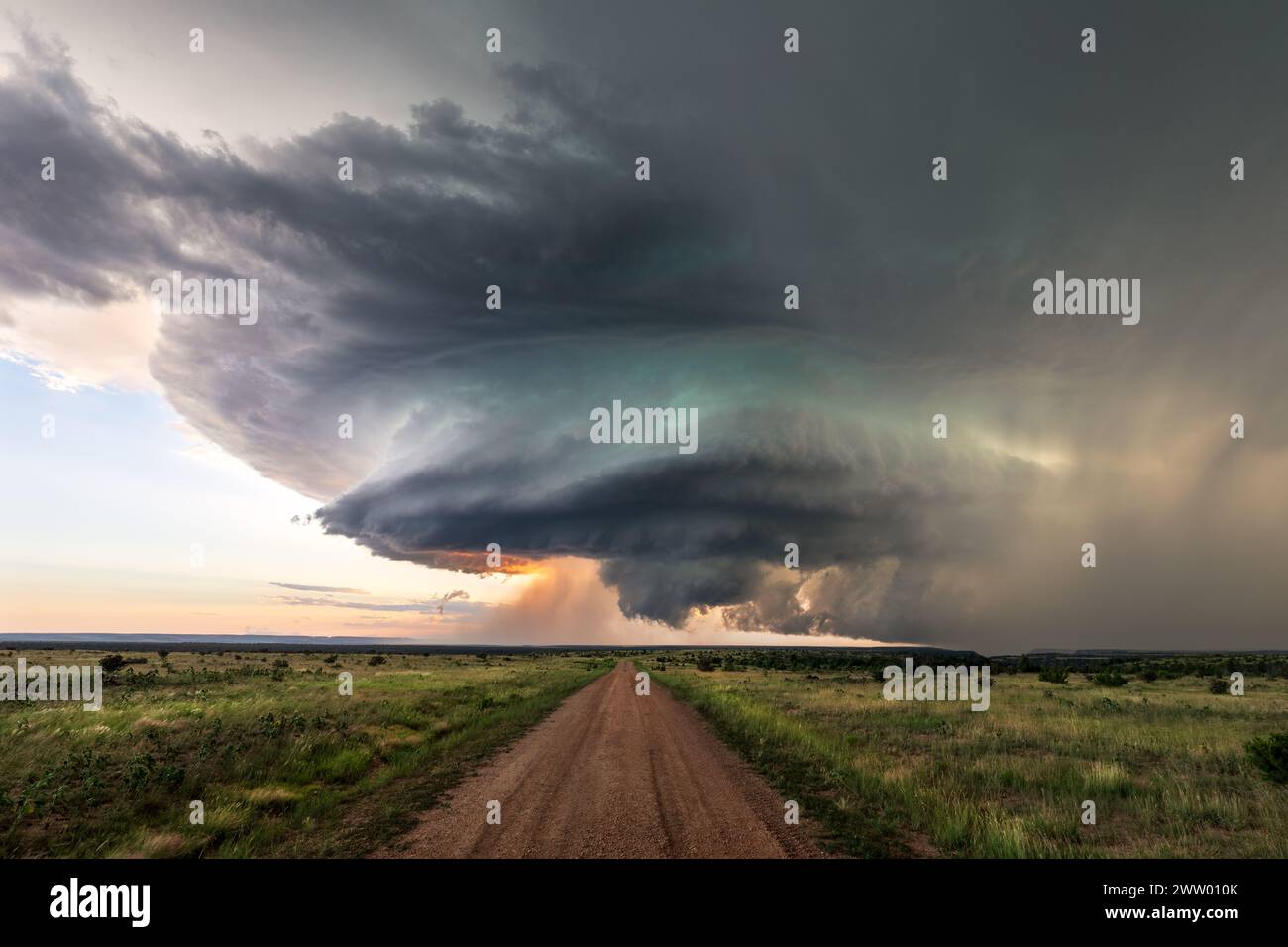 Dirt road leading to supercell storm clouds in Colorado Stock Photo