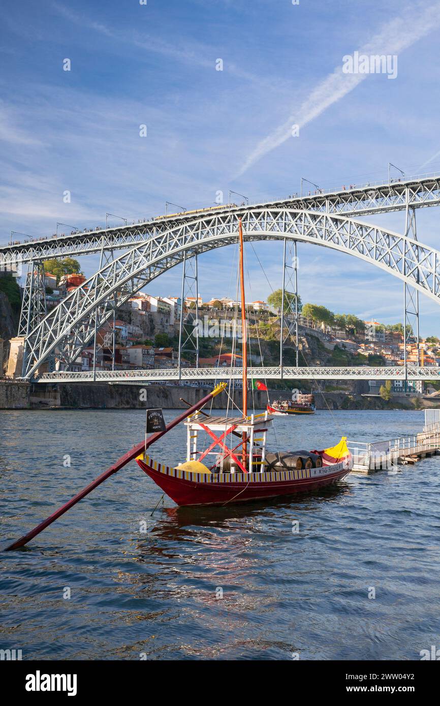Portugal, Porto, Vila Nova de Gaia, Luís I Bridge (Ponte Luís I) across the Douro River with Traditional Wooden Boat Stock Photo
