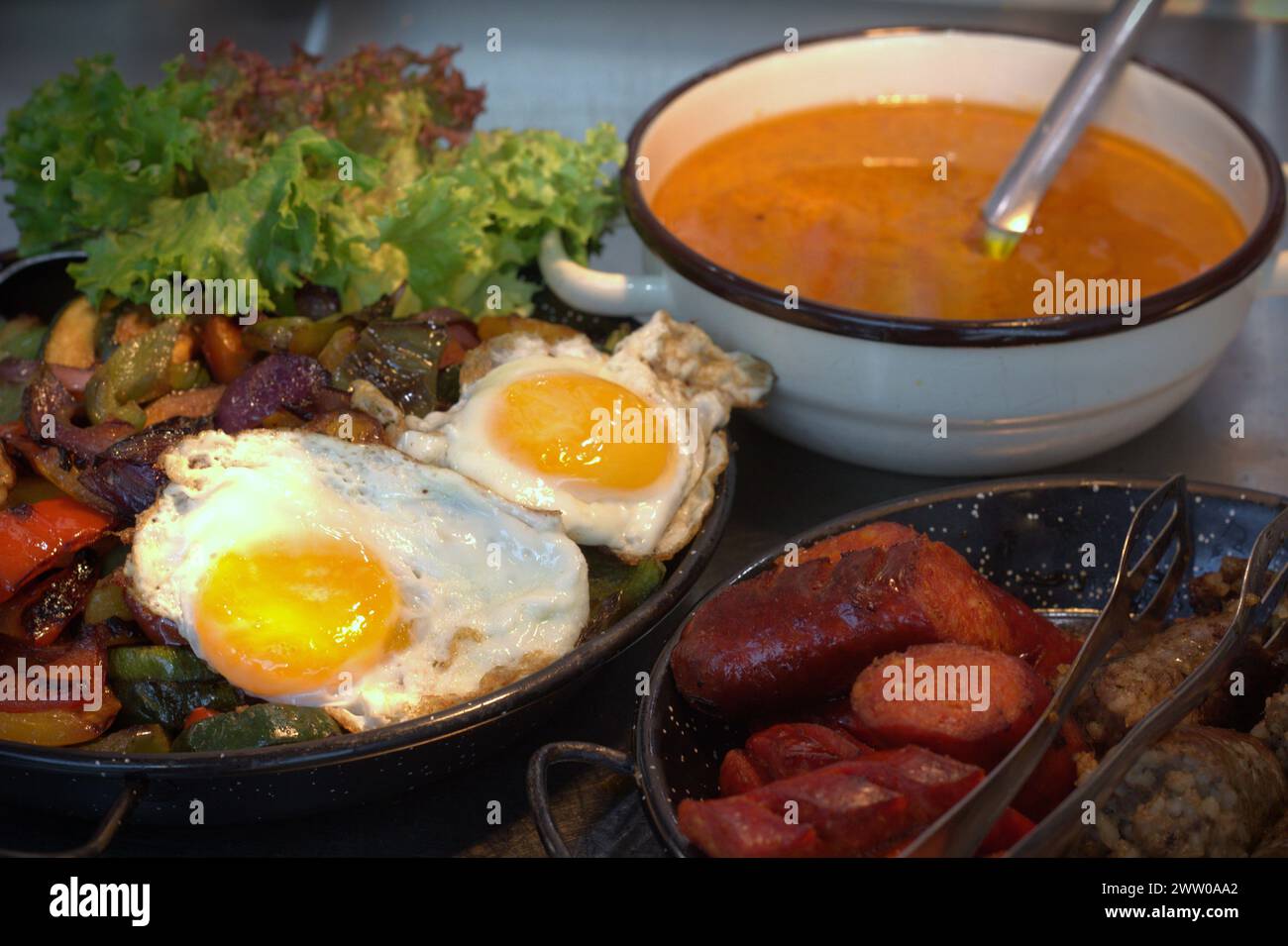 Healthy diet - stewed veggies and fried eggs nicely arranged on a table Stock Photo