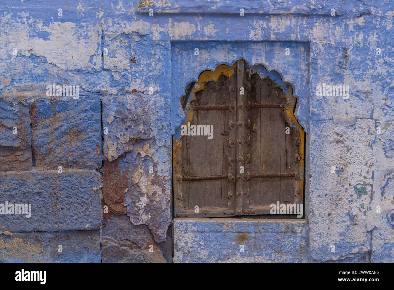 Wood door with a blue wall in the blue city of Jodhpur, Rajasthan