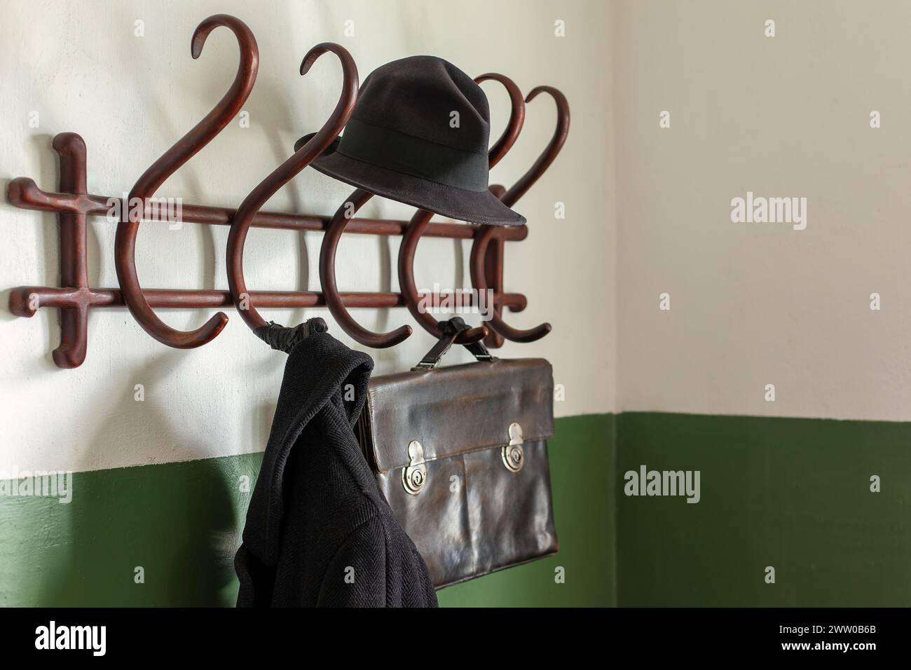 Clothes hanger. Old wooden clothes hanger. Return home from the street. Classic hanging poll. vintage coat and hat hanger in the old style. Stock Photo