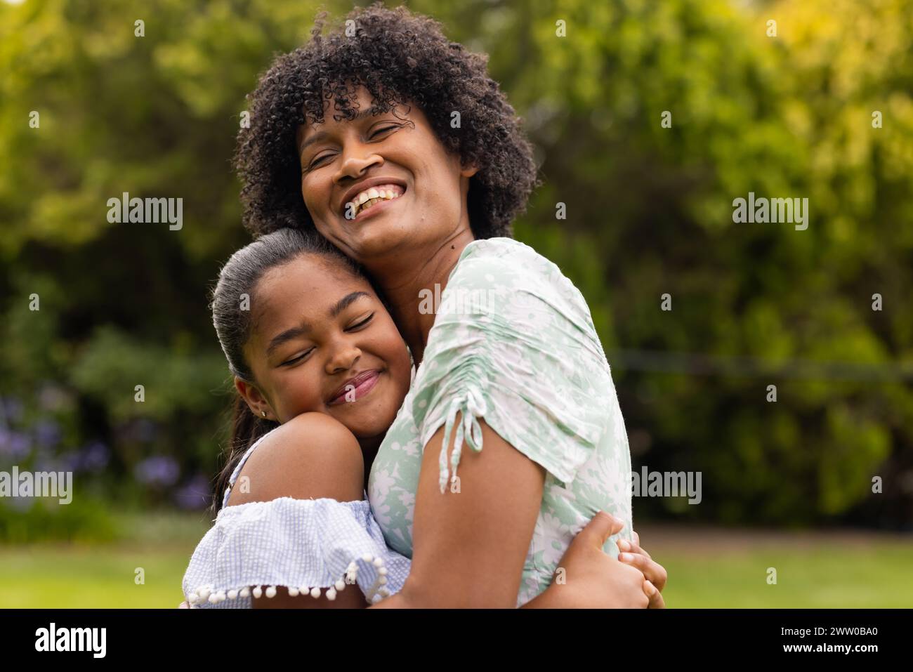 African American mother and daughter share a warm embrace outdoors Stock Photo