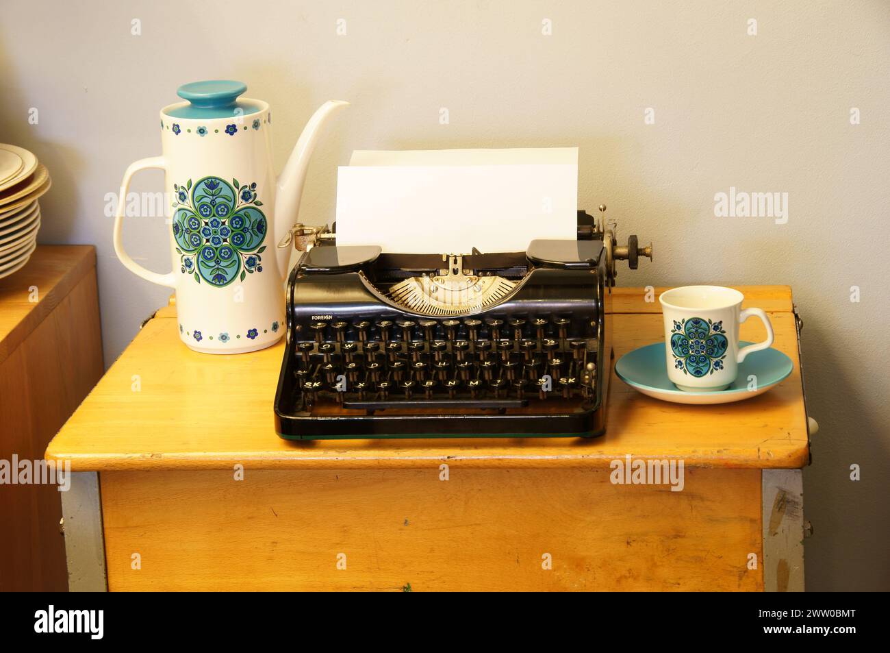Graphic art and photography for writers of a retro typewriter, vintage coffee pots, tea pots and tea cups. Stock Photo