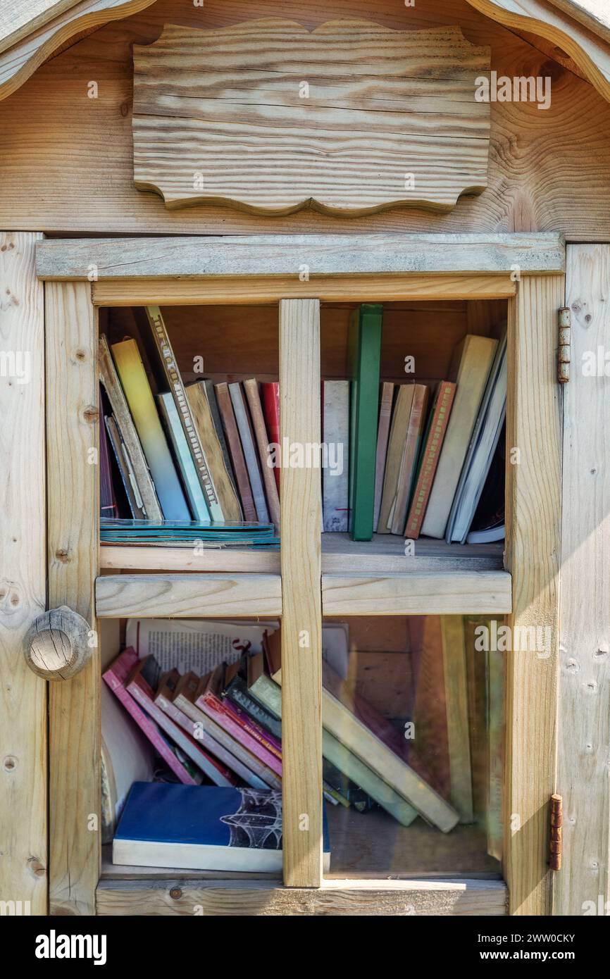 Outdoor free book sharing mini house in close up, full frame photo. Stock Photo