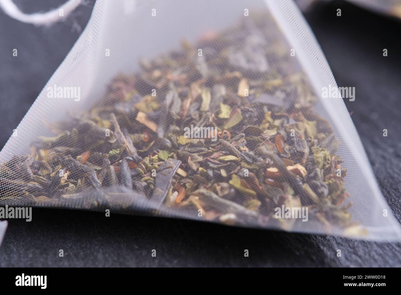Triangular teabag with tea on a slate Stock Photo