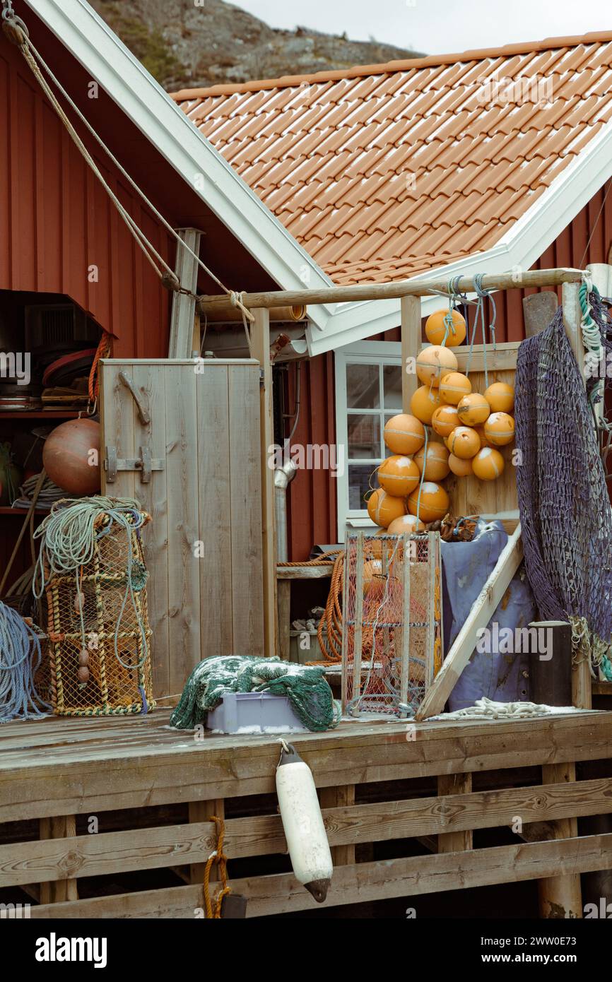 Fishing utilities at red wooden fishing village hut. Stock Photo