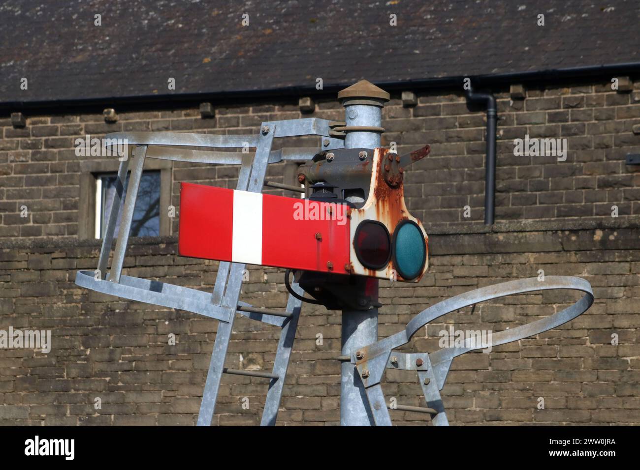Arm of red semaphore signal in stop position situated at end of platform 1 at Carnforth railway station. Stock Photo