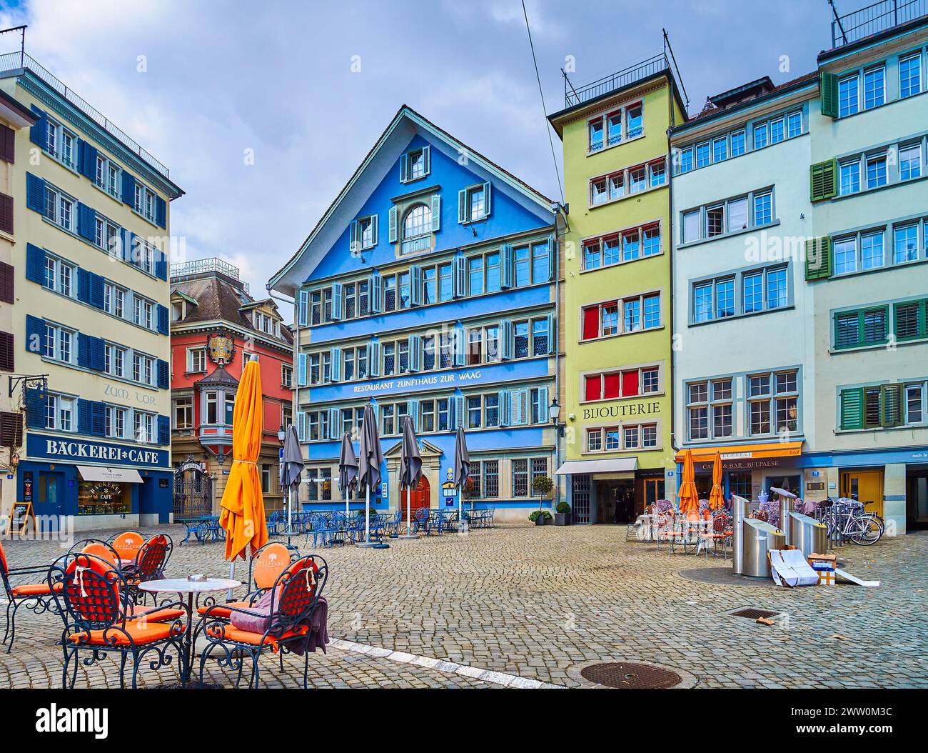 ZURICH, SWITZERLAND - APRIL 3, 2022: Munsterhof Square's medieval townhouses with atmospheric restaurant outdoor seating, on April 3 in Zurich, Switze Stock Photo