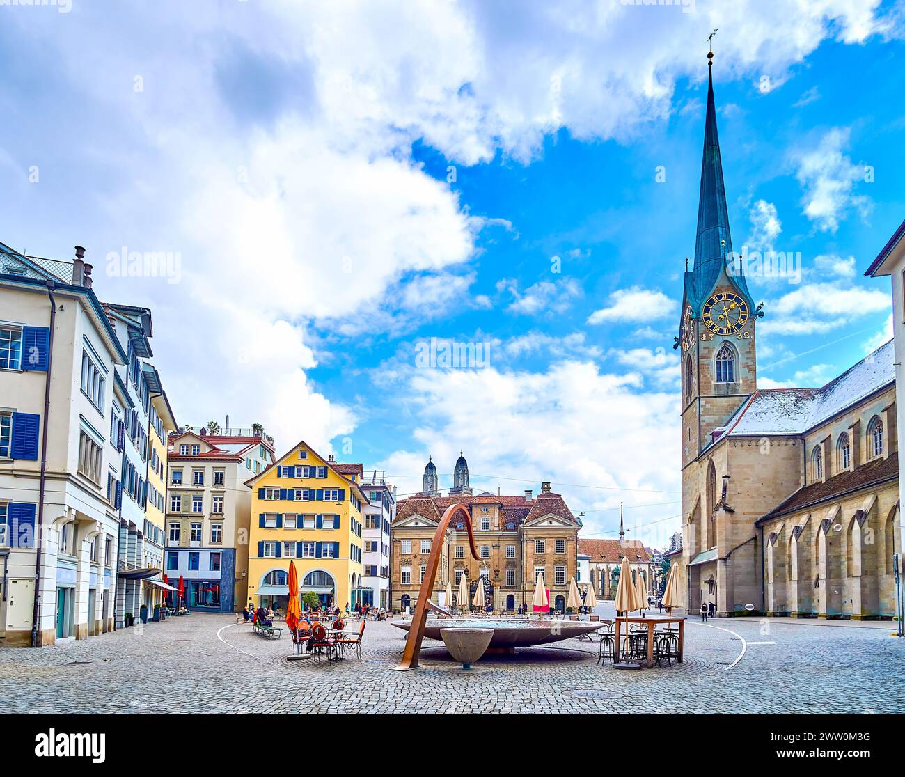 Munsterhof Brunnen fountain and Fraumunster church on background, Munsterhof square in Zurich, Switzerland Stock Photo