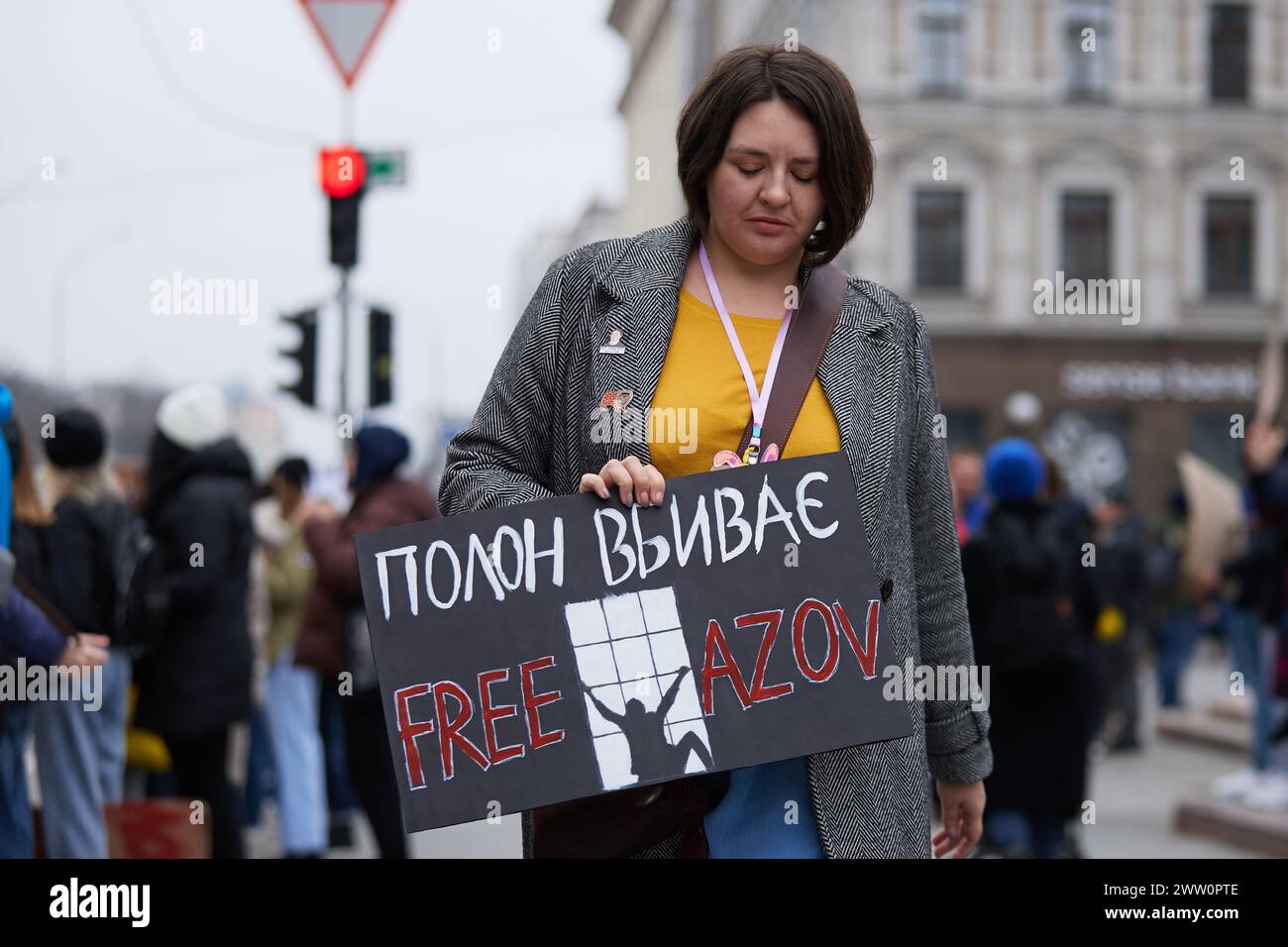 Female person walks with a sign 