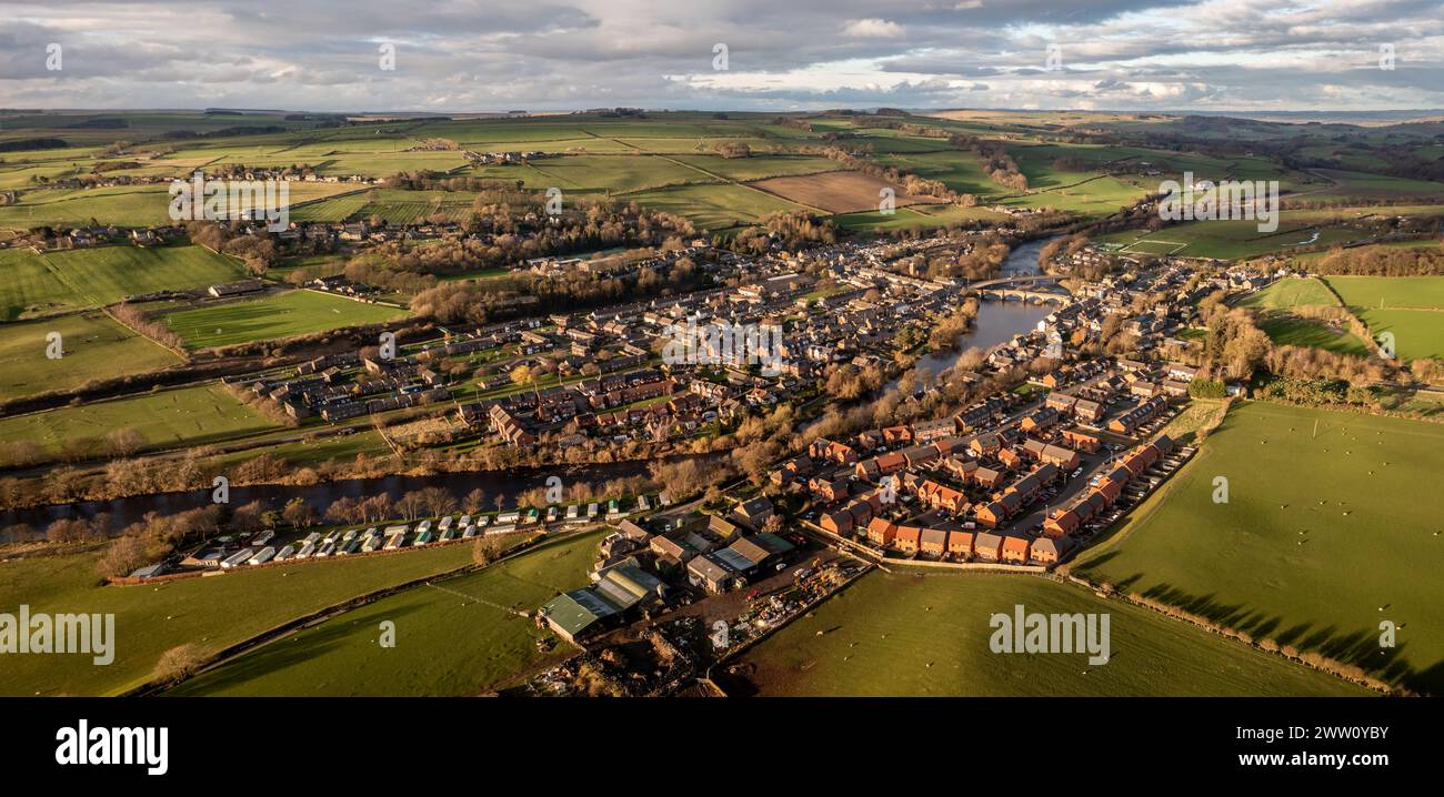 An aerial panoramic landscape of the village of Haydon Bridge in the Northumberland National Park with the River Tyne running through Stock Photo