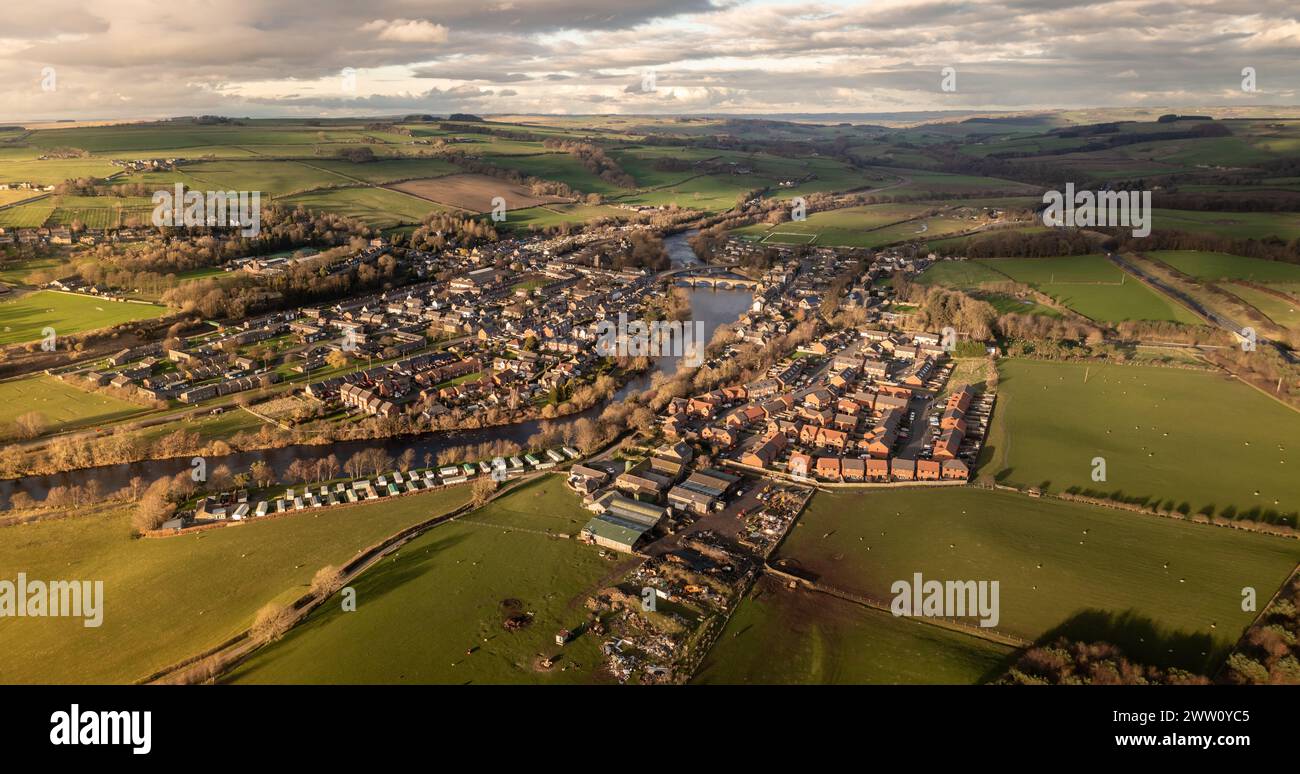An aerial panoramic landscape of the village of Haydon Bridge in the Northumberland National Park with the River Tyne running through Stock Photo