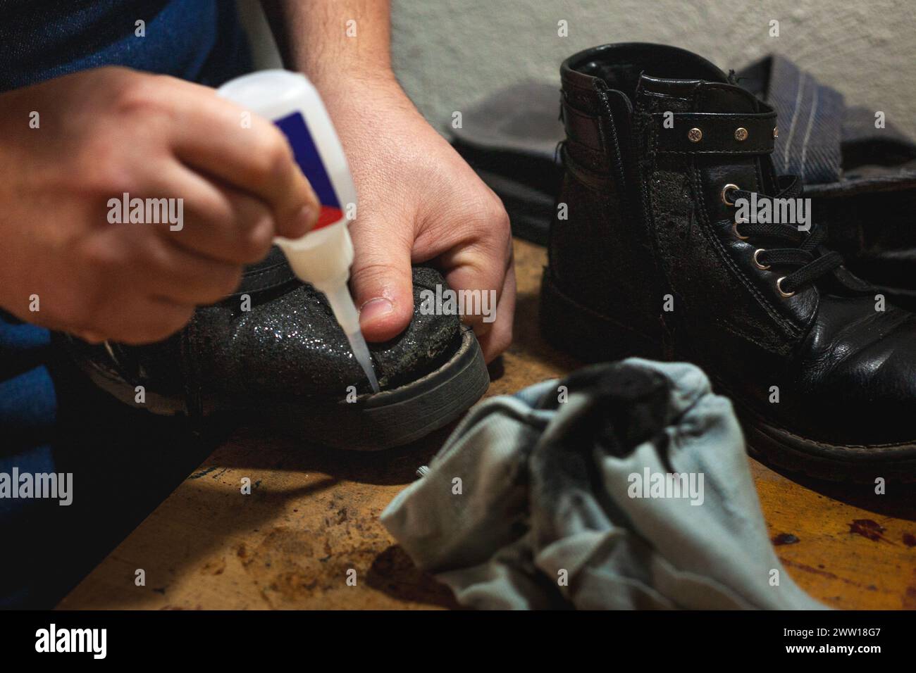Shoemaker's hands gluing shoe soles Stock Photo