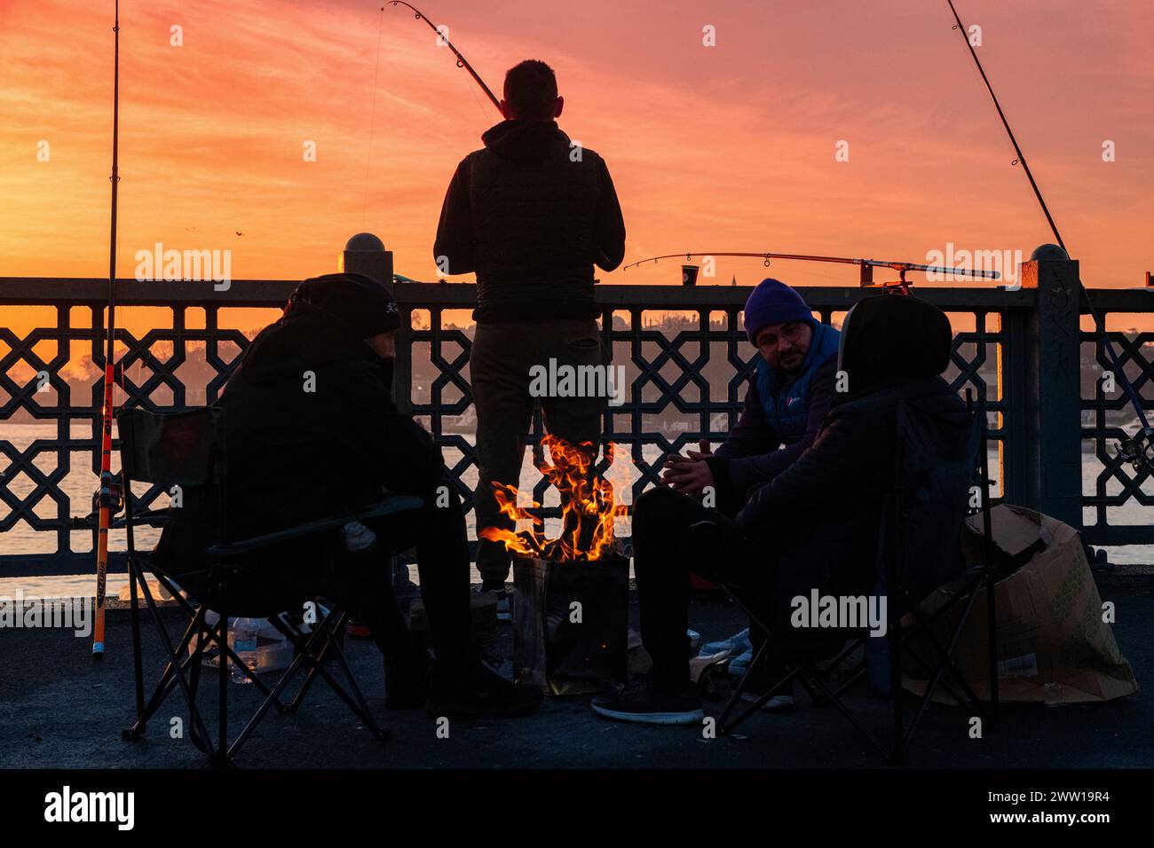 Fishermen enjoying sunrise in Istanbul at the Galata Bridge, Turkey Stock Photo
