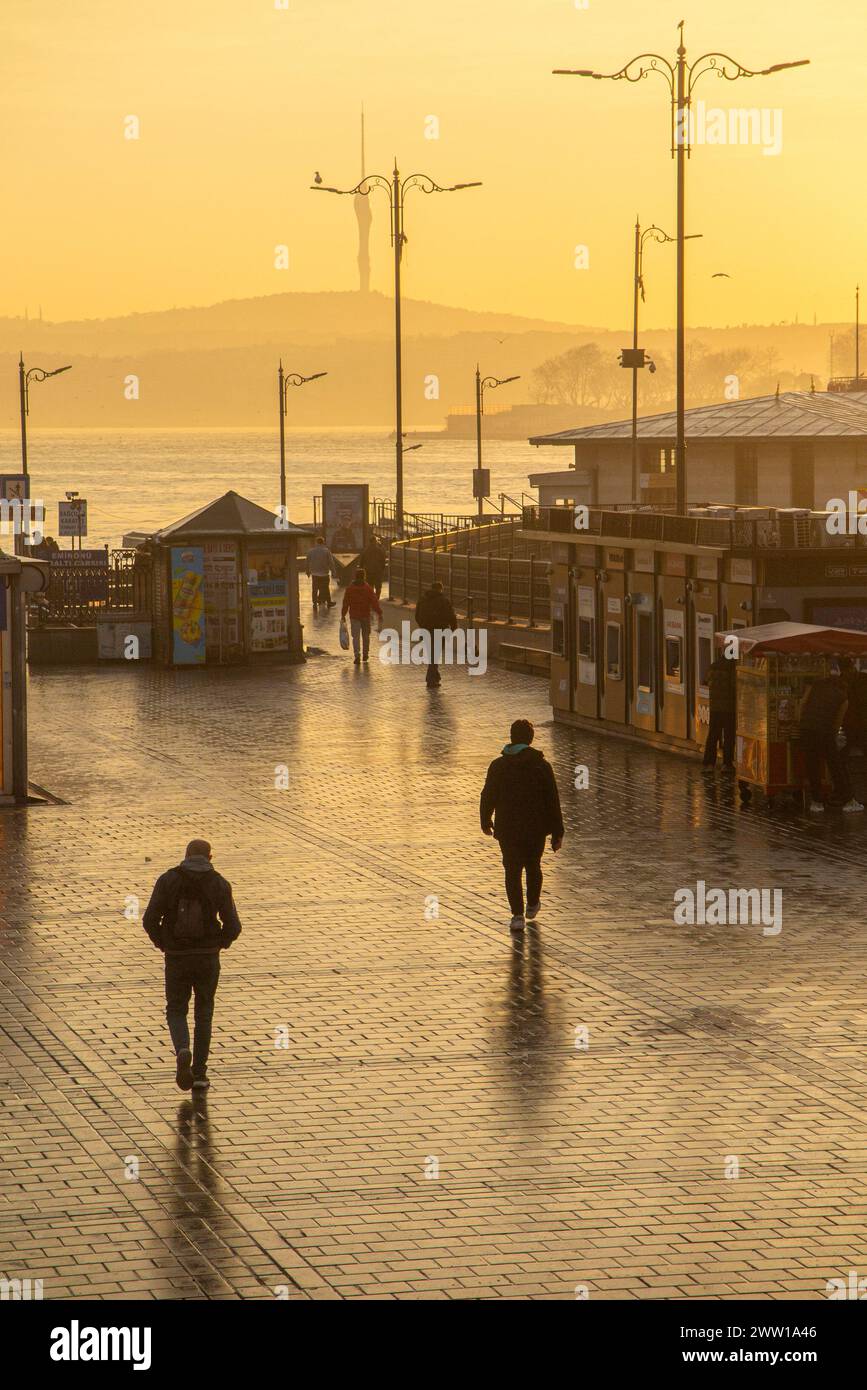 Istanbulites go about their daily lives in the City, walking to the station at dawn. Stock Photo
