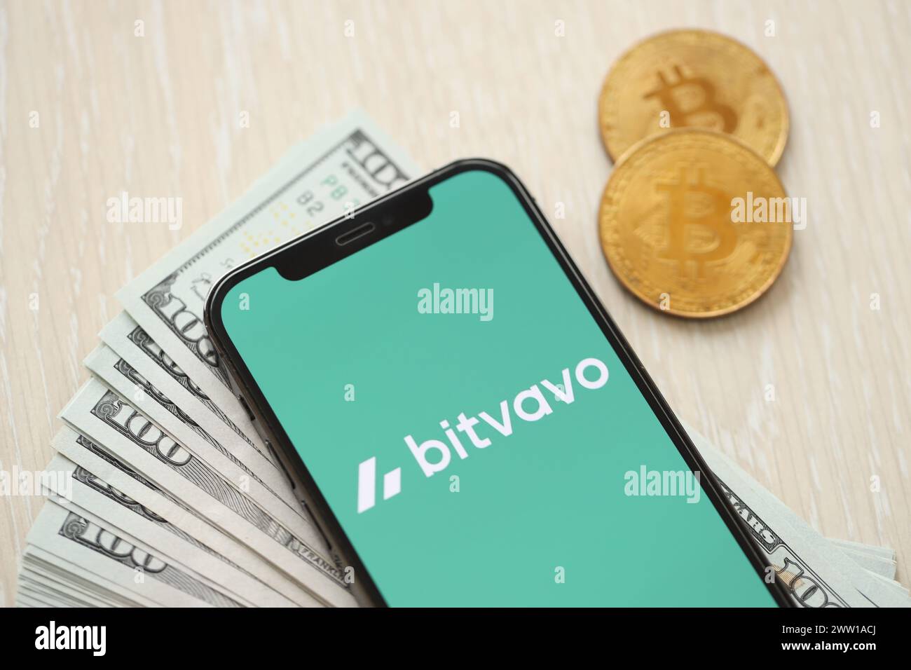 Bitvavo app logo on smartphone in hand with the Netherlands blurred flag  background. European cryptocurrency exchange platform Stock Photo - Alamy
