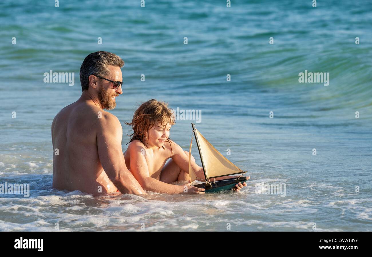 daddy and son family vacation. Thrilling adventure vacation. fatherhood of father and son outdoor playing together. Creating sea adventures with a toy Stock Photo