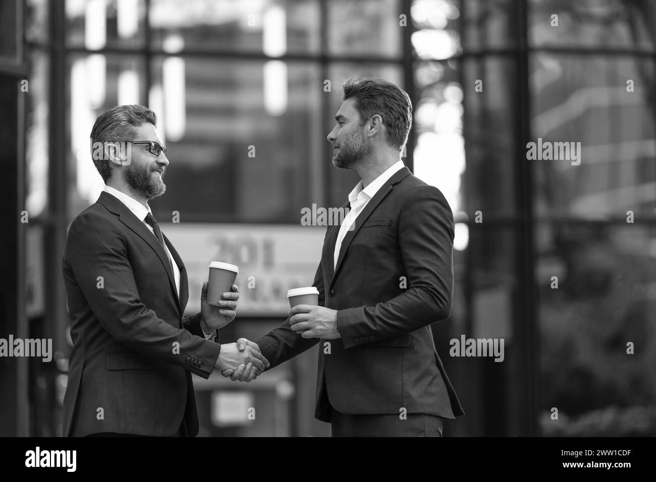 Financial partner shake hands Black and White Stock Photos & Images - Alamy