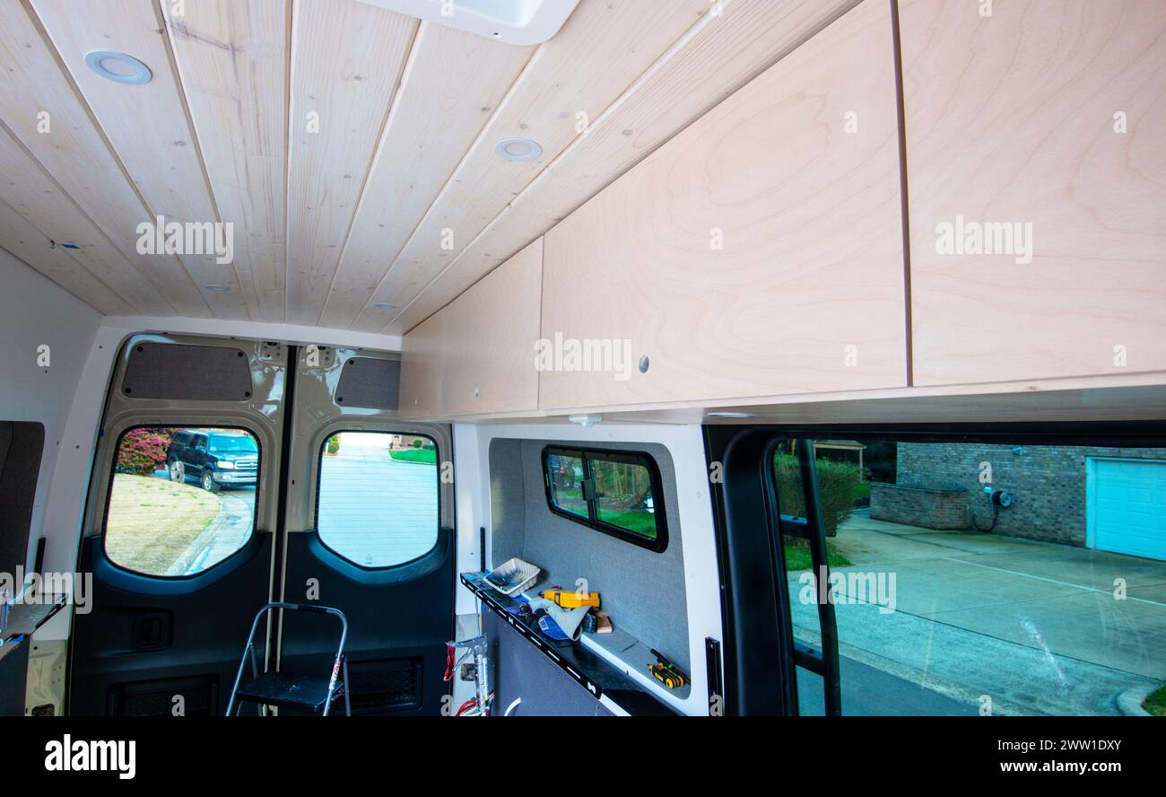 Tongue and groove 1x6 and diy upper cabinets built for  Mercedes Benz sprinter cargo van conversion to mobil home. Cary, North Carolina, Stock Photo