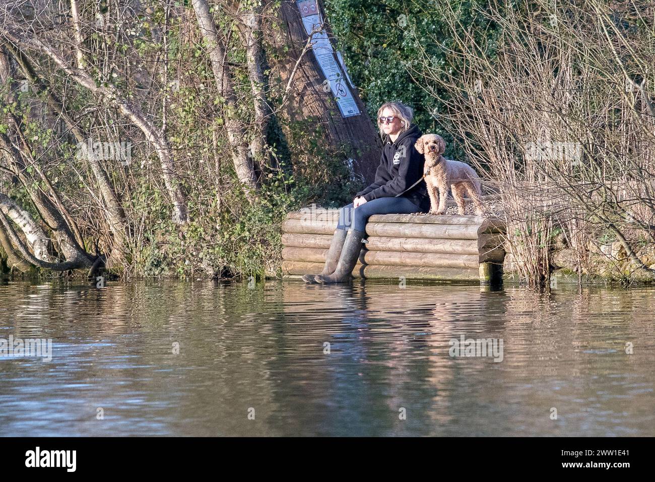 Brittens Pond, Worplesdon. 20th March 2024. Sunny weather across the Home Counties this afternoon. A young lady enjoying the weather at Brittens Pond in Worpleson, near Guildford, in Surrey. Credit: james jagger/Alamy Live News Stock Photo