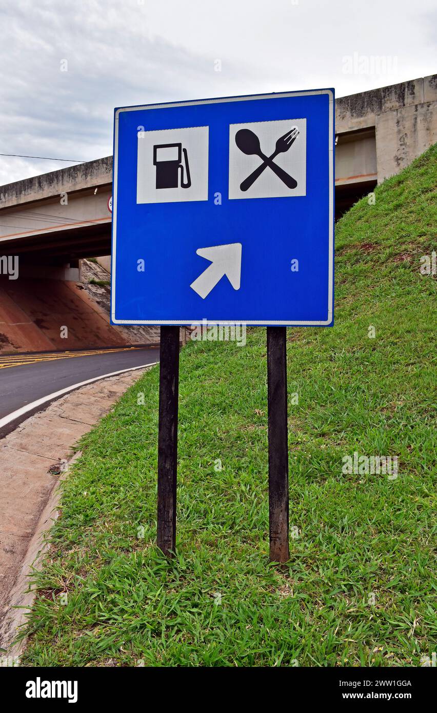 Traffic sign indicating the way to the gas station and restaurant in Ribeirao Preto, Sao Paulo, Brazil Stock Photo