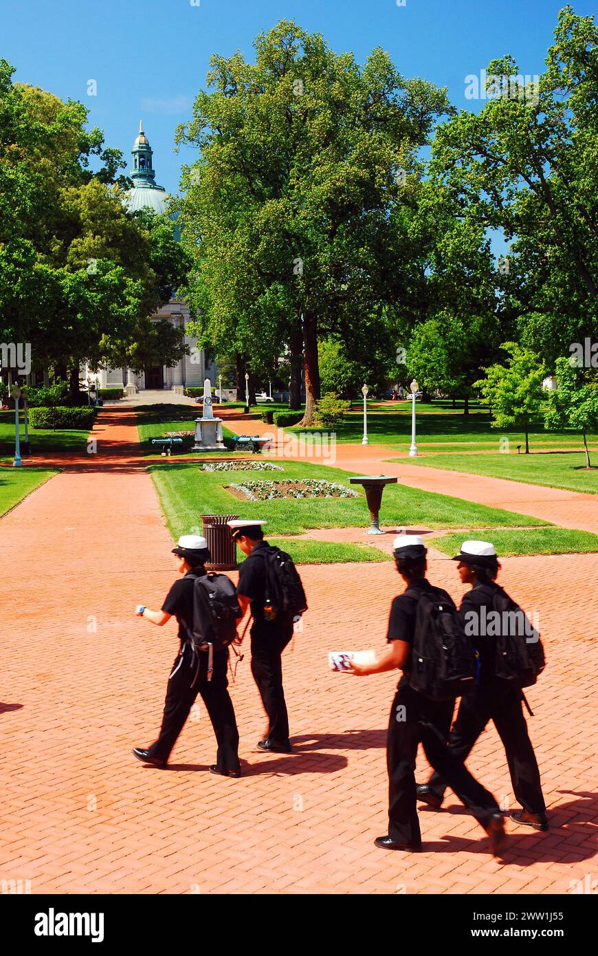 Midshipman at the US Naval Academy in Annapolis walk across their campus in uniform Stock Photo
