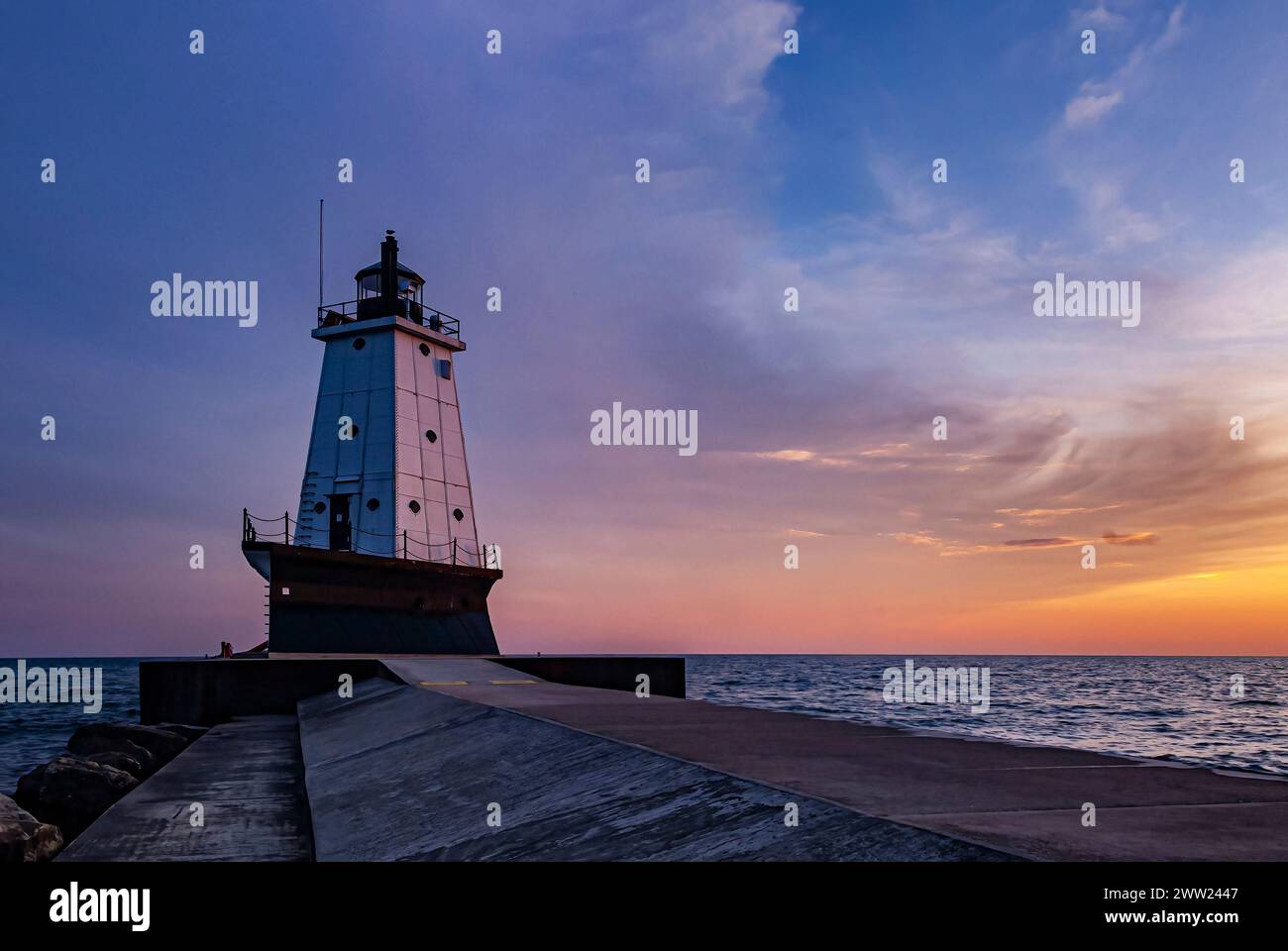 The Ludington Pier Lighthouse is shown at sunset, on Lake Michigan, Ludington, Mason County, Michigan Stock Photo