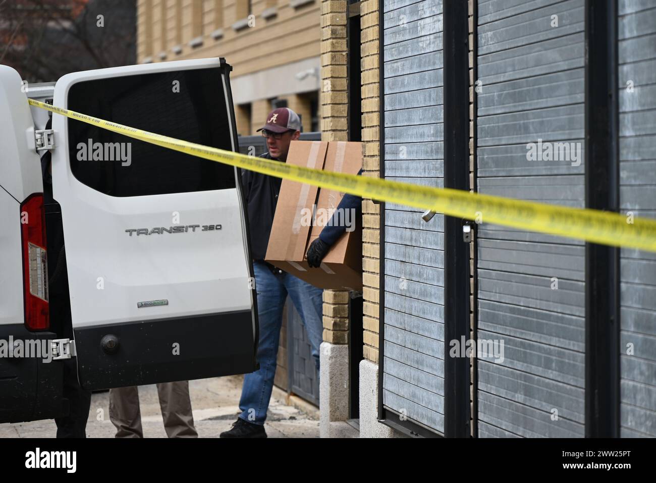 FBI agents load boxes of evidence collected from a warehouse into a