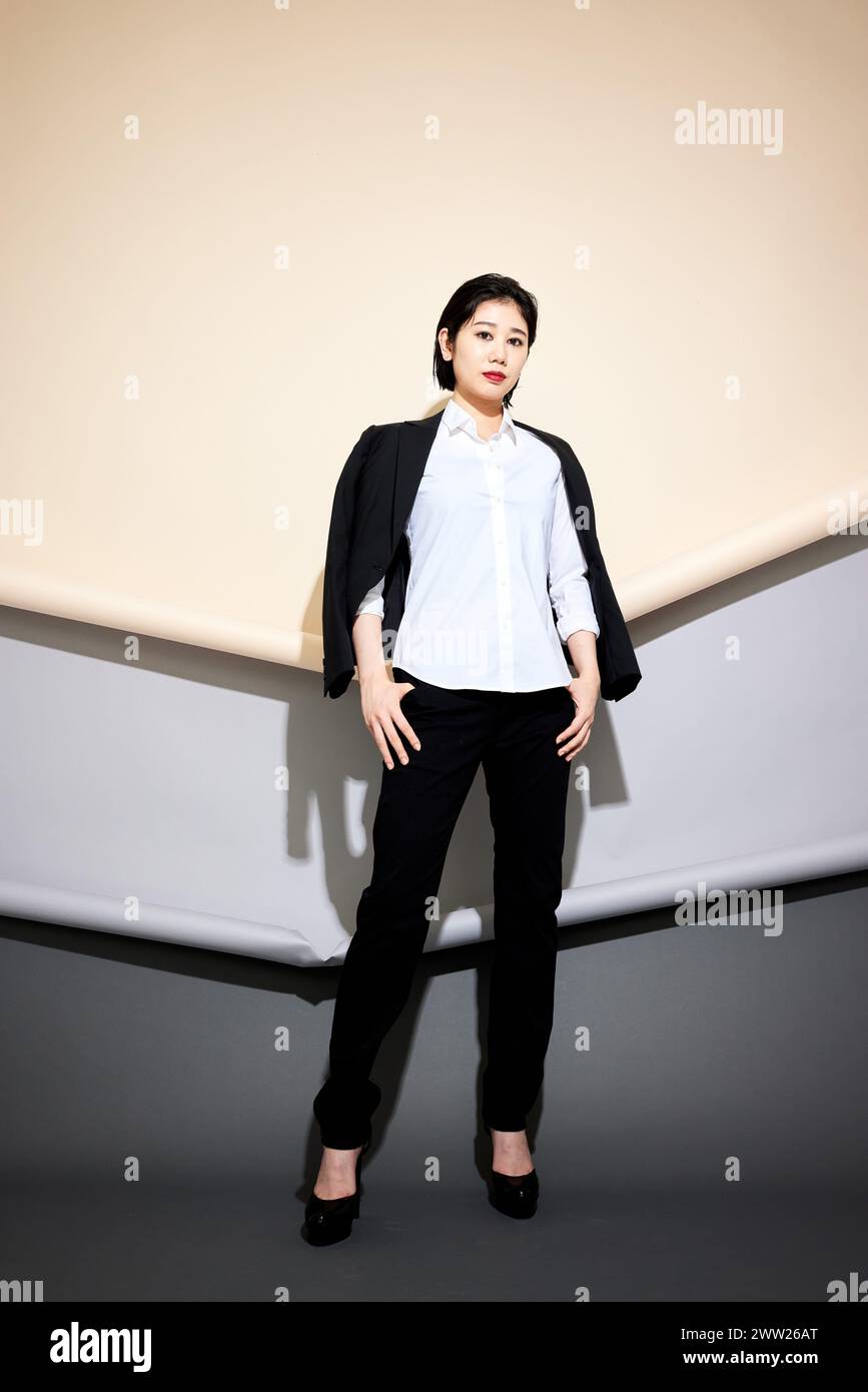 A woman in a white shirt and black pants Stock Photo