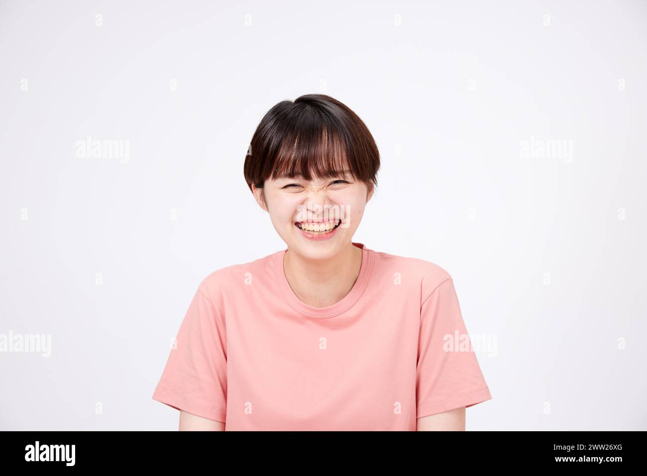 A woman in a pink shirt smiling Stock Photo
