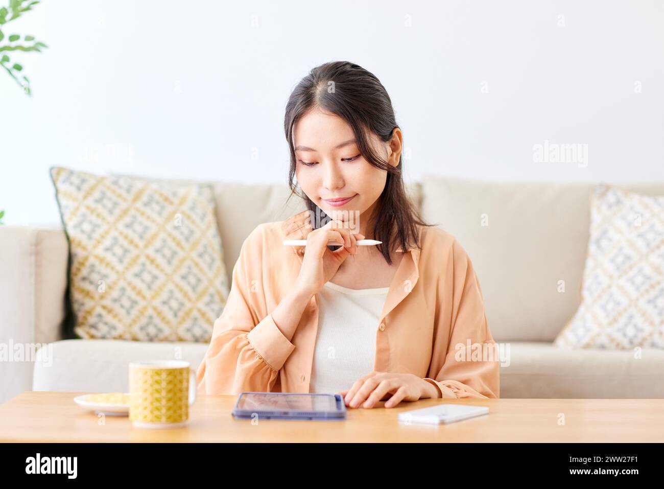 Asian woman using tablet at home Stock Photo