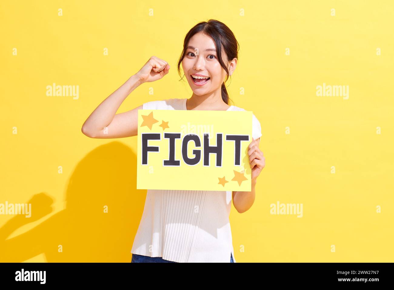 A woman holding up a sign that says fight Stock Photo