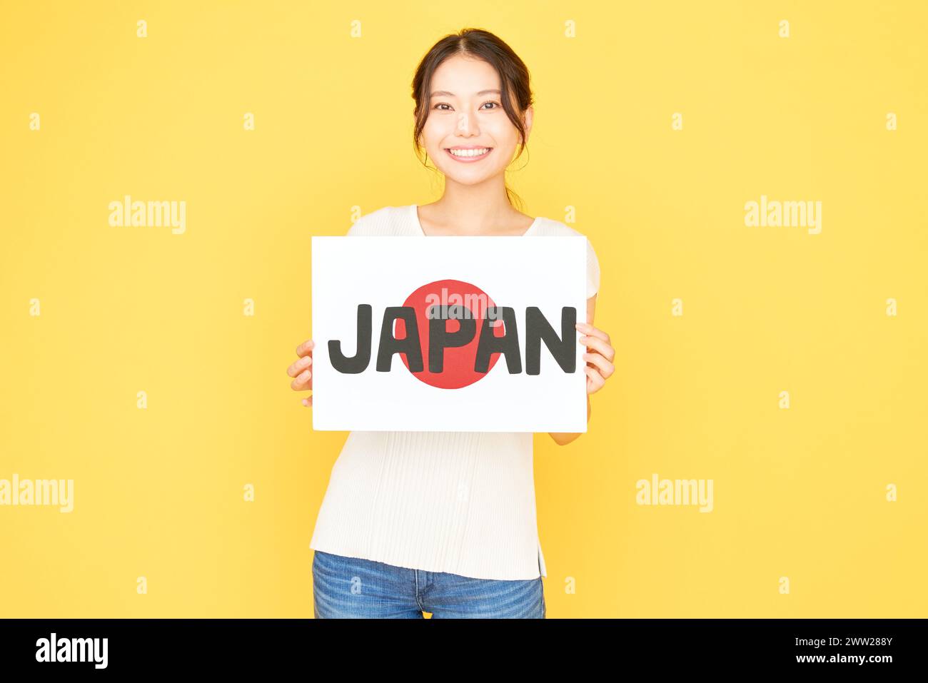 Japanese woman holding up a sign with the word Japan Stock Photo