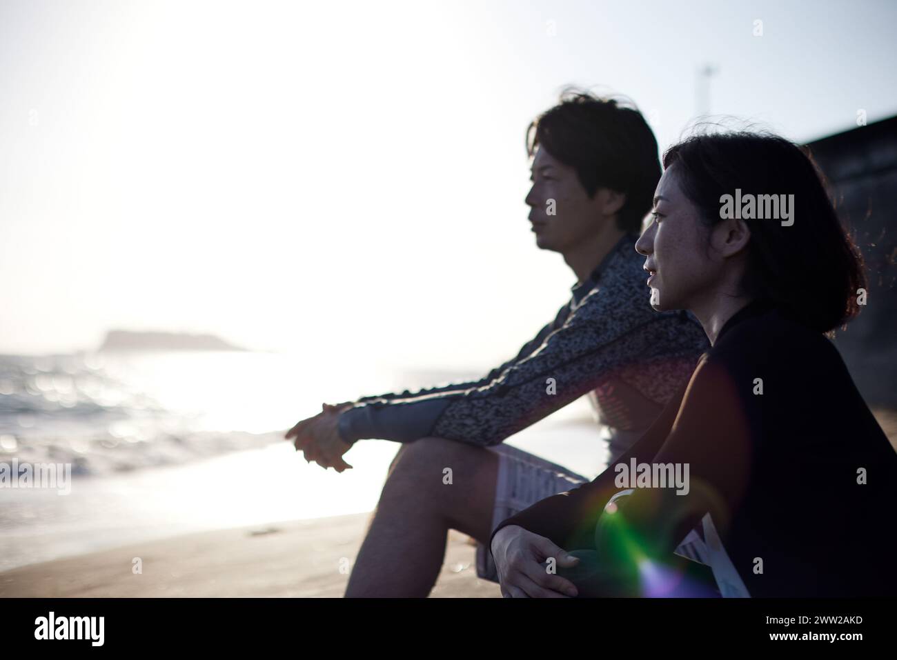 A man and woman sitting on the beach Stock Photo