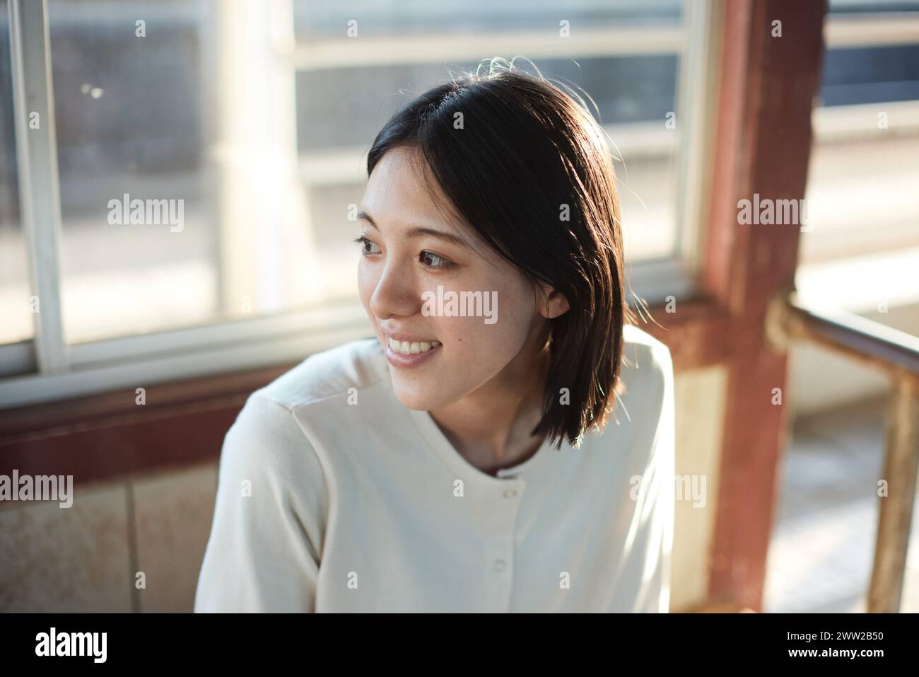 Asian woman smile sitting bench hi-res stock photography and images - Alamy