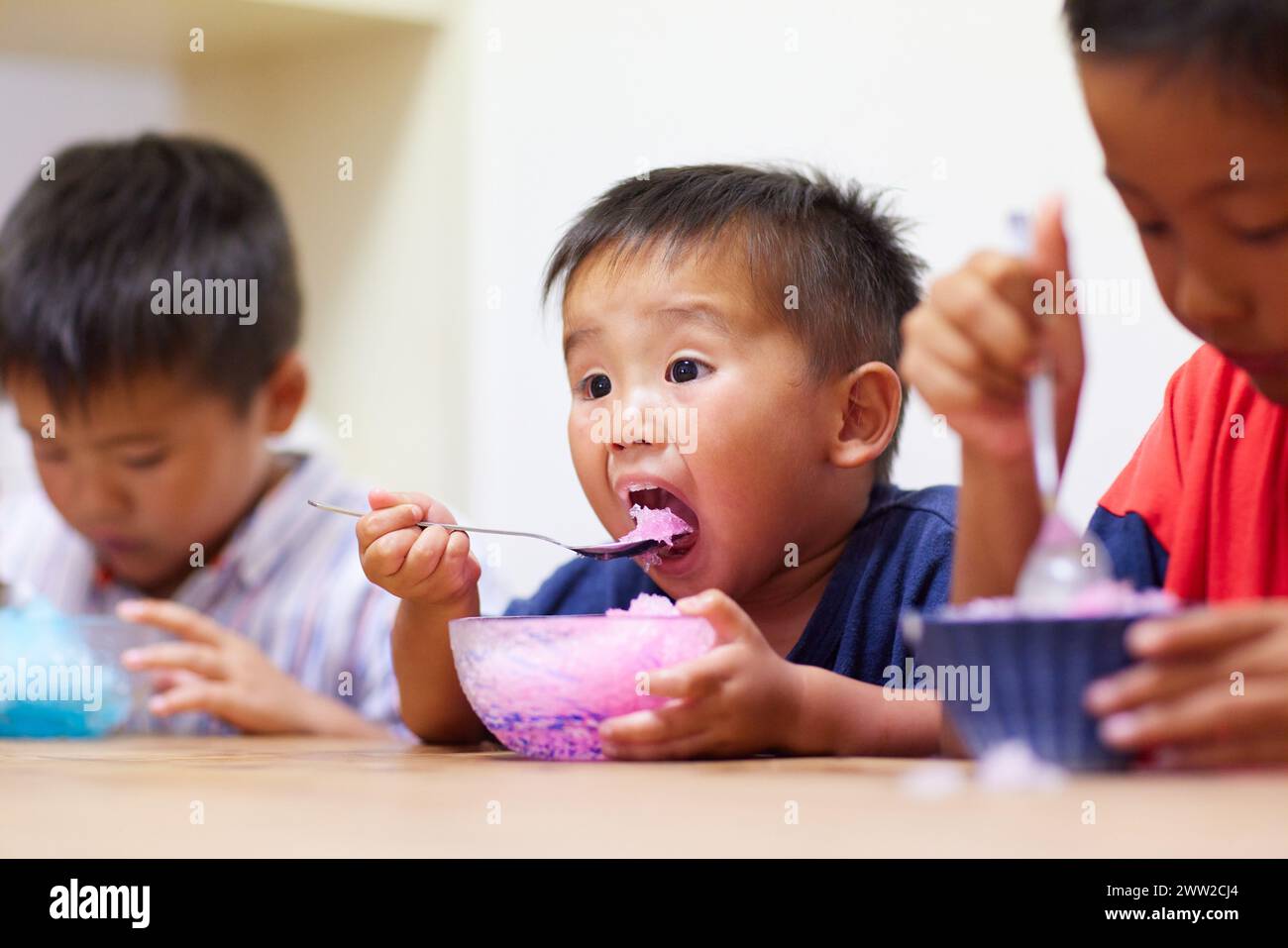 Kids eating shaved ice Stock Photo