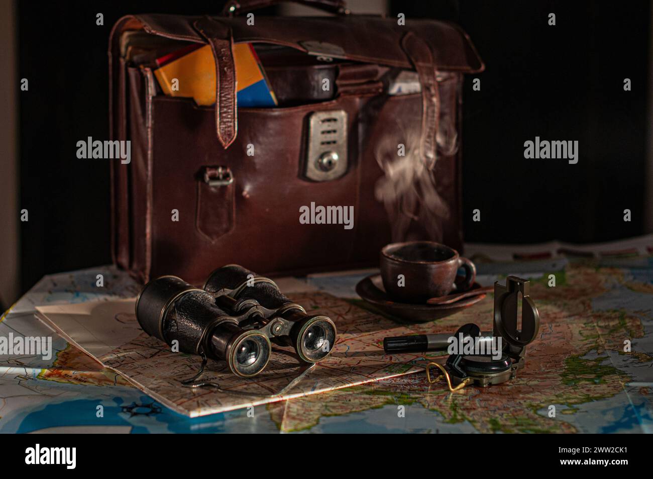 Check the list of travel necessities such as maps, compasses, stationery, bags and binoculars Stock Photo