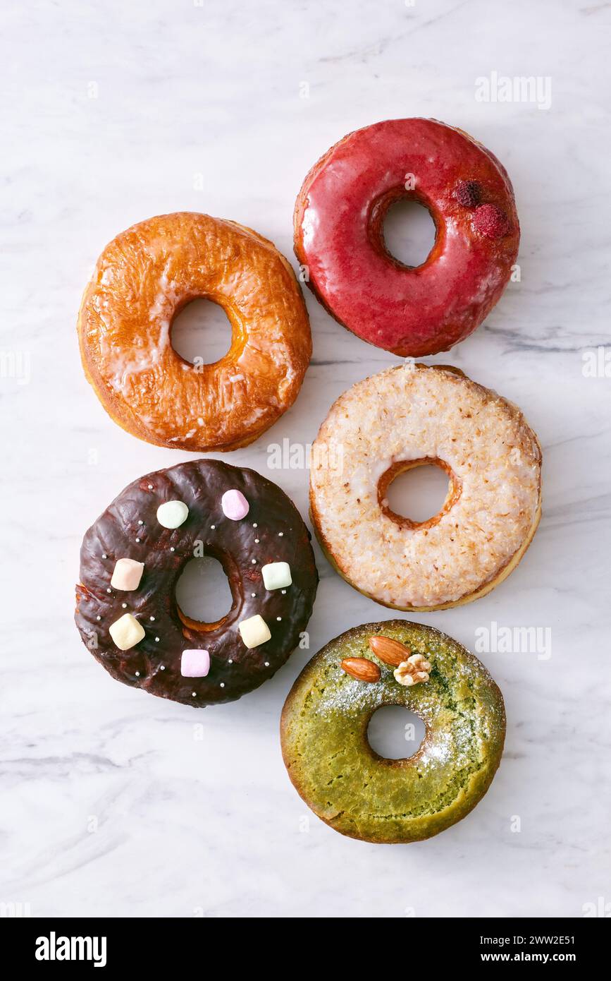 A group of donuts with different toppings Stock Photo