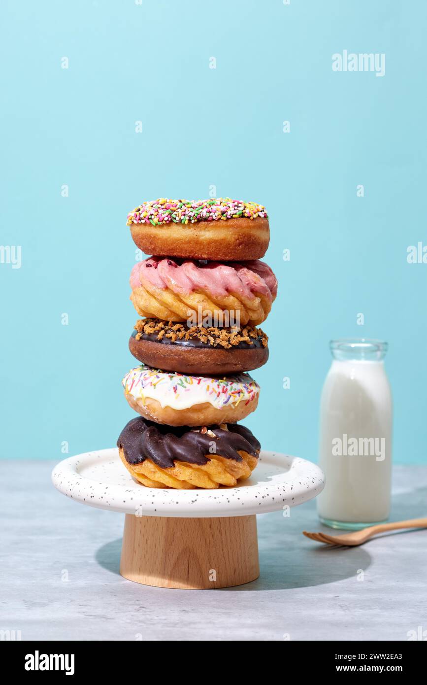 A stack of donuts on a wooden stand with milk Stock Photo