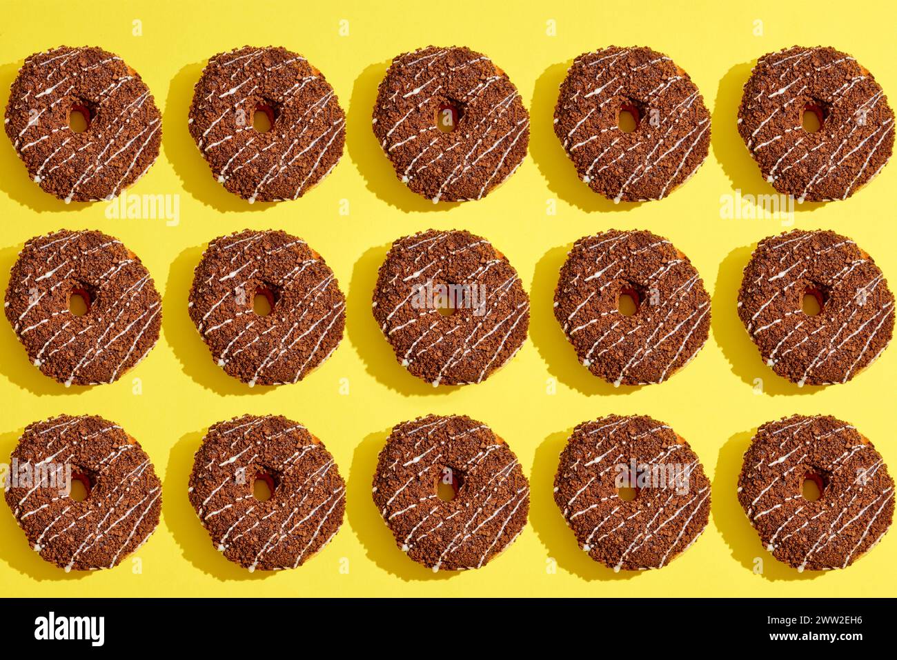 A pattern of donuts on a yellow background Stock Photo