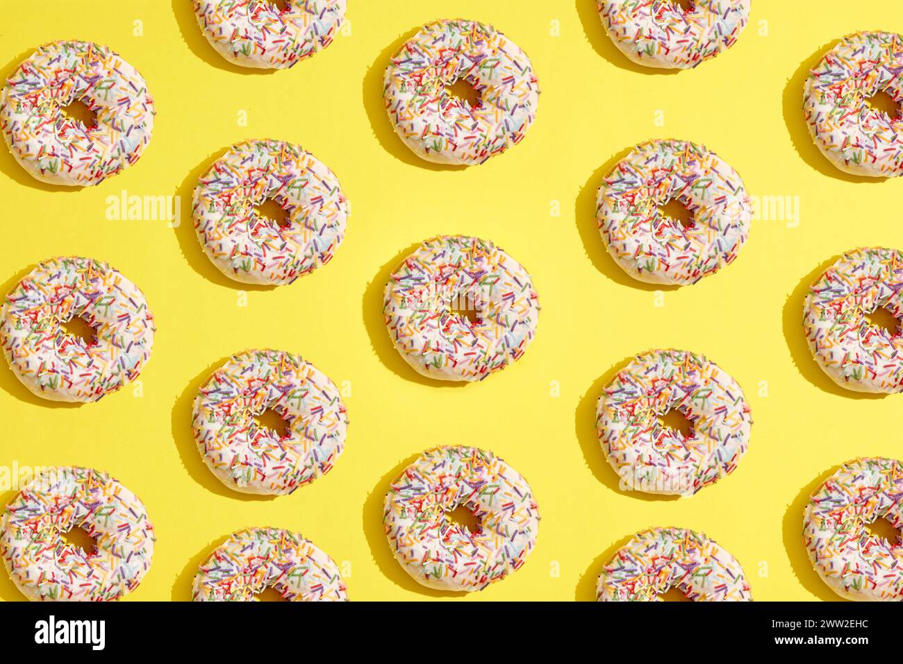 A pattern of donuts on a yellow background Stock Photo