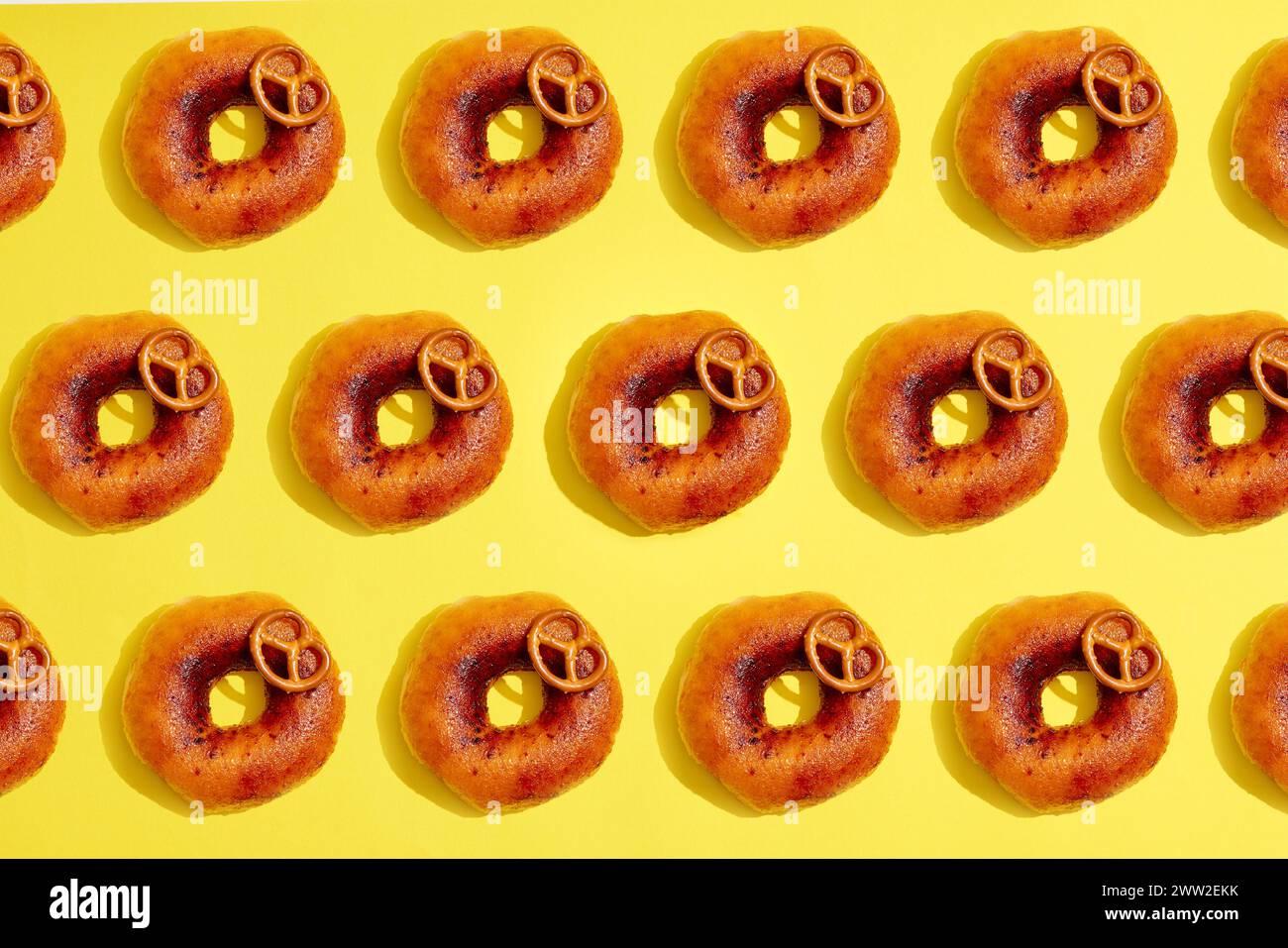 A pattern of donuts on a yellow background Stock Photo - Alamy