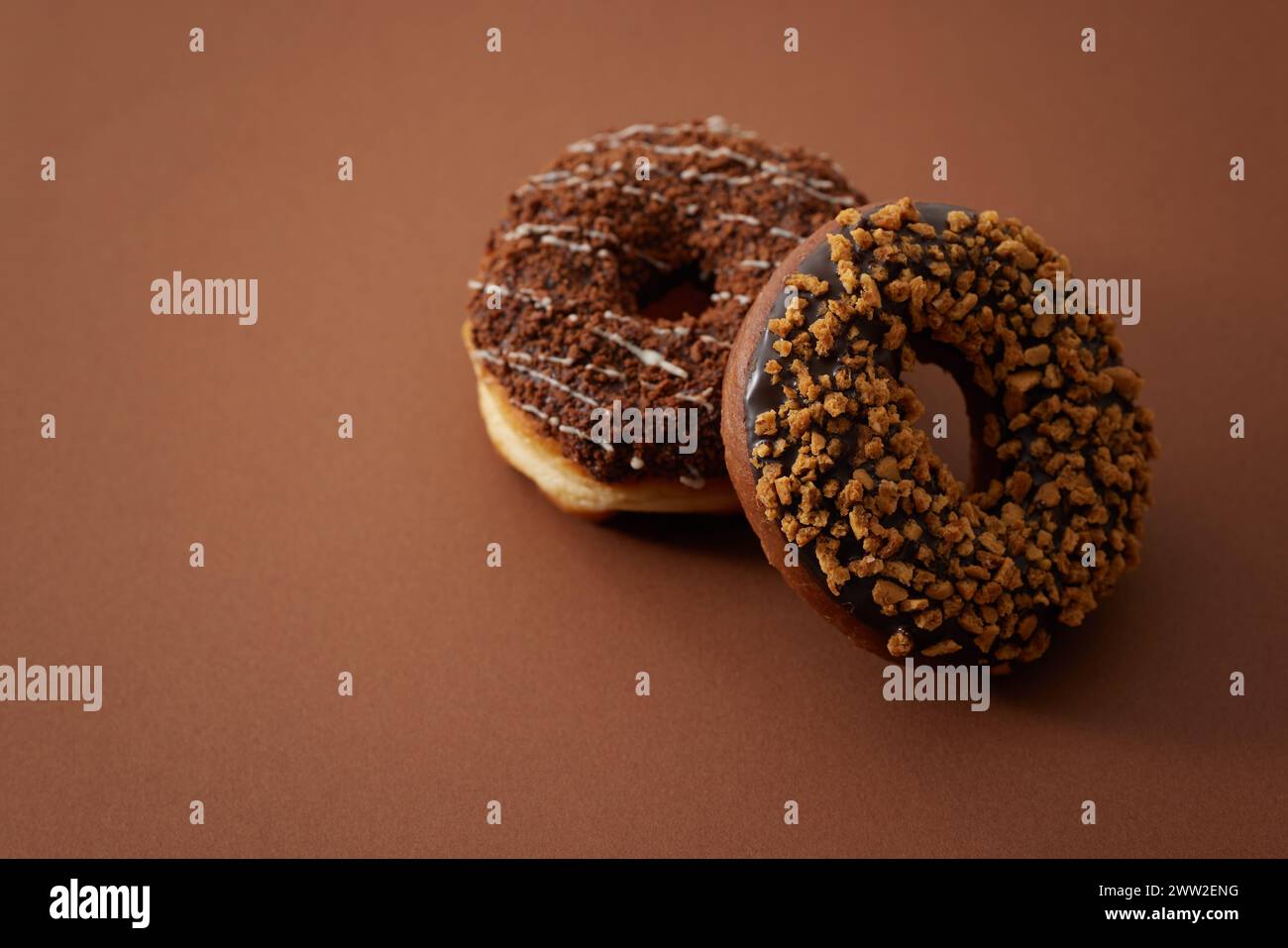 Two donuts on a brown surface Stock Photo