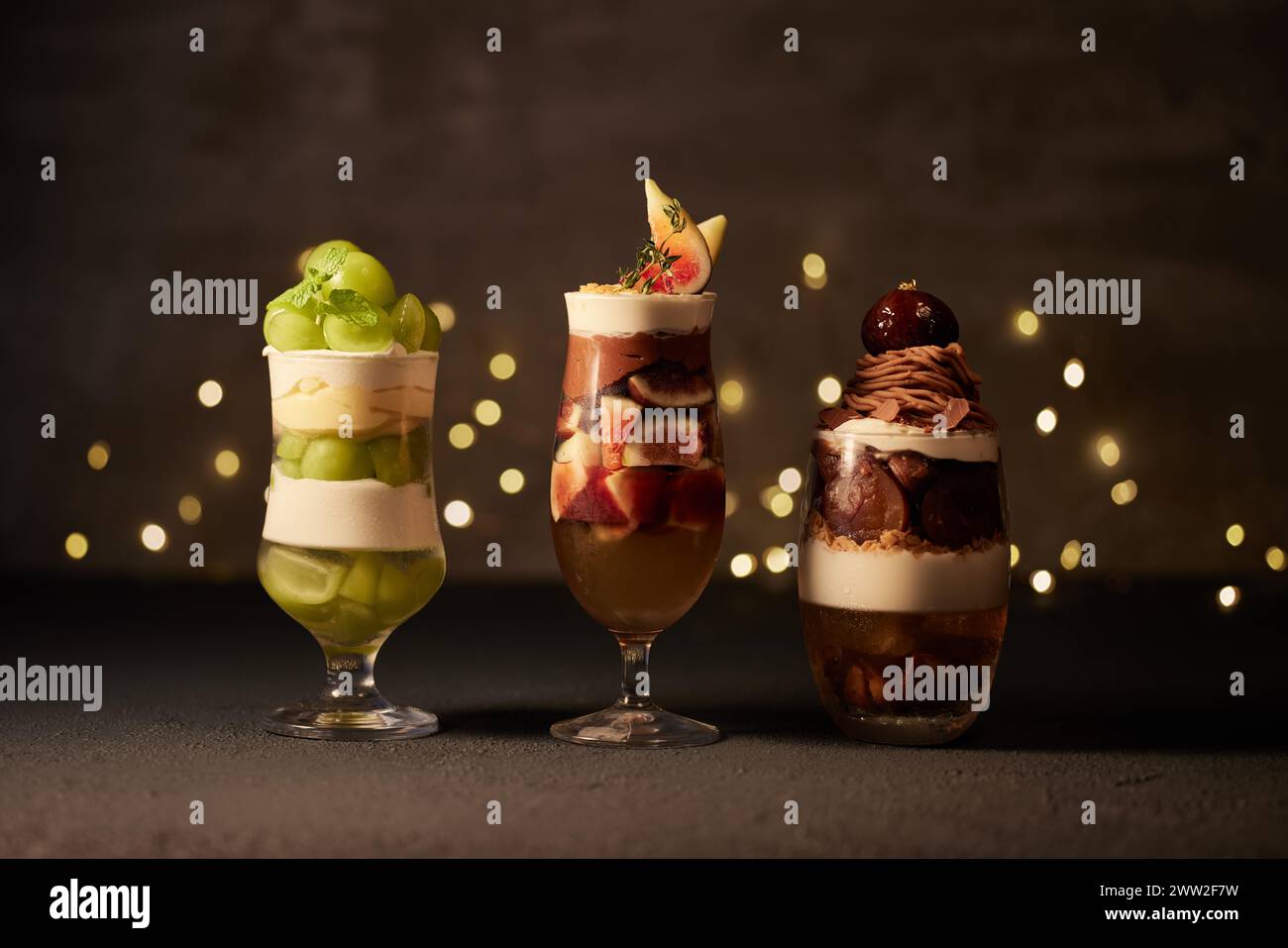 Three different desserts in glasses on a dark background Stock Photo