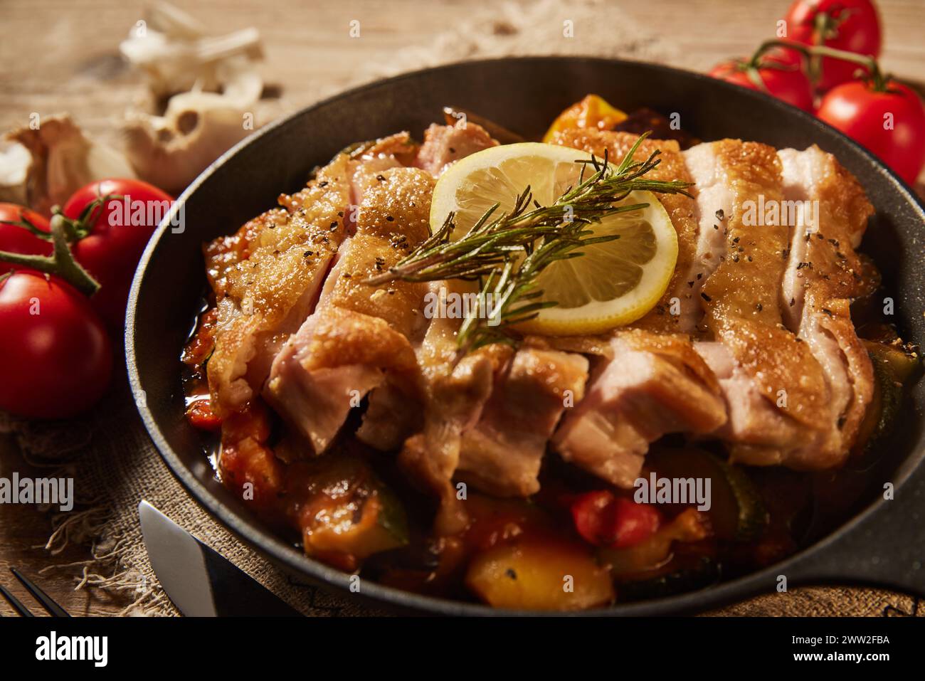 A pan with chicken vegetables and tomatoes Stock Photo