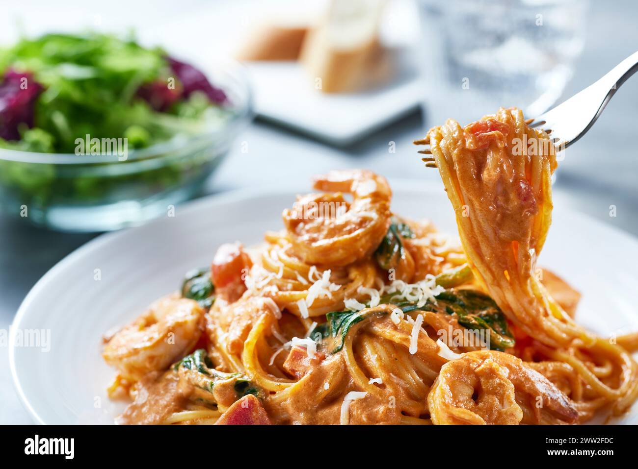A plate of spaghetti with shrimp and spinach Stock Photo